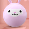 A pink inflatable hopper ball with a white face design is displayed on a light pink stand.