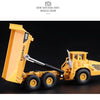 A yellow 1:87 scale articulated dumper truck diecast model with a raised hydraulic lift arm.