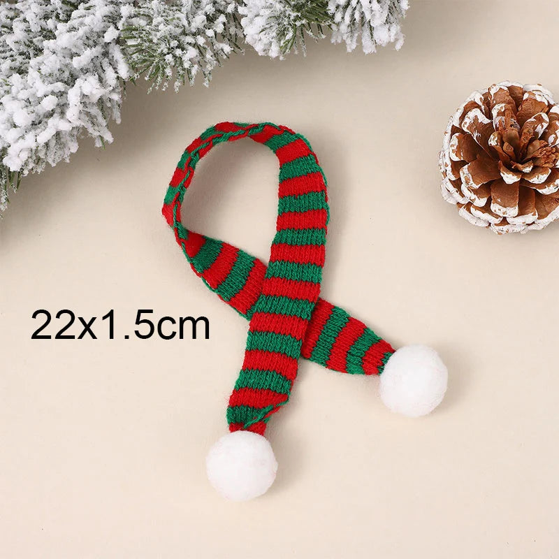 A set of mini knit Christmas hats and scarves in red and green stripes with white pom-poms, displayed on a light background.