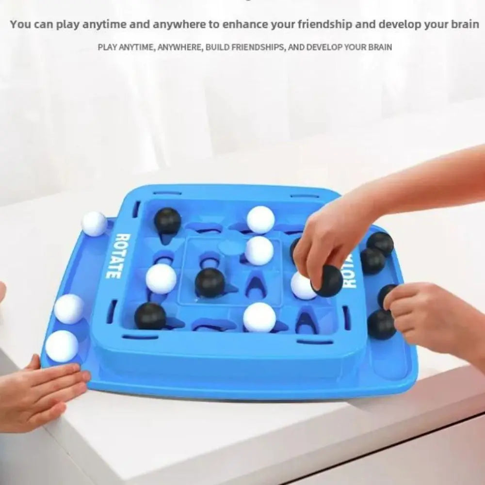 A hand is playing a blue strategy board game with black and white pieces on a white table.