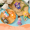 A set of six cute sleeping reborn baby dolls in various colors and outfits arranged on a wooden board.