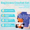 A beginner crochet kit featuring a small orange fox toy made from yarn and crochet tools.