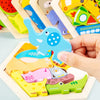 A hand holds a wooden 3D jigsaw puzzle featuring a blue elephant and various colorful animal shapes.