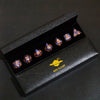 A set of handmade resin polyhedral dice in a black box with a gold star design.
