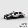A black and white classic rally car building block set with a red interior.