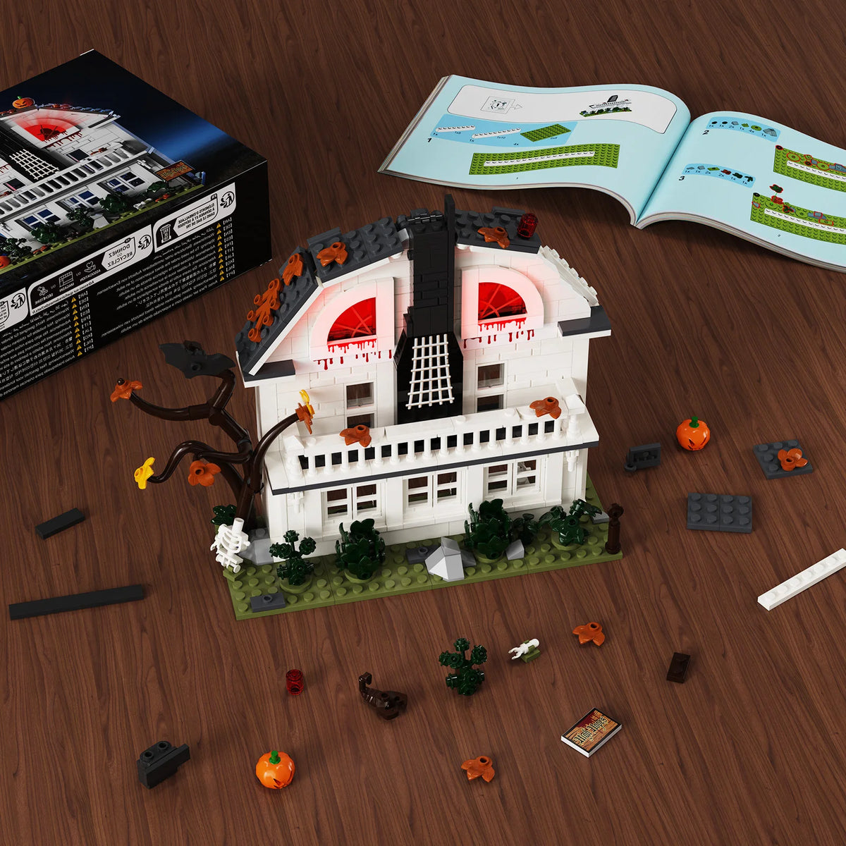 A set of haunted horror house building blocks featuring a white house model and movie-inspired accessories on a wooden surfac