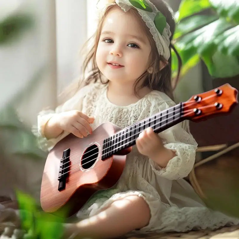 A young girl is holding a pink acoustic guitar toy with a ukulele sound effect.