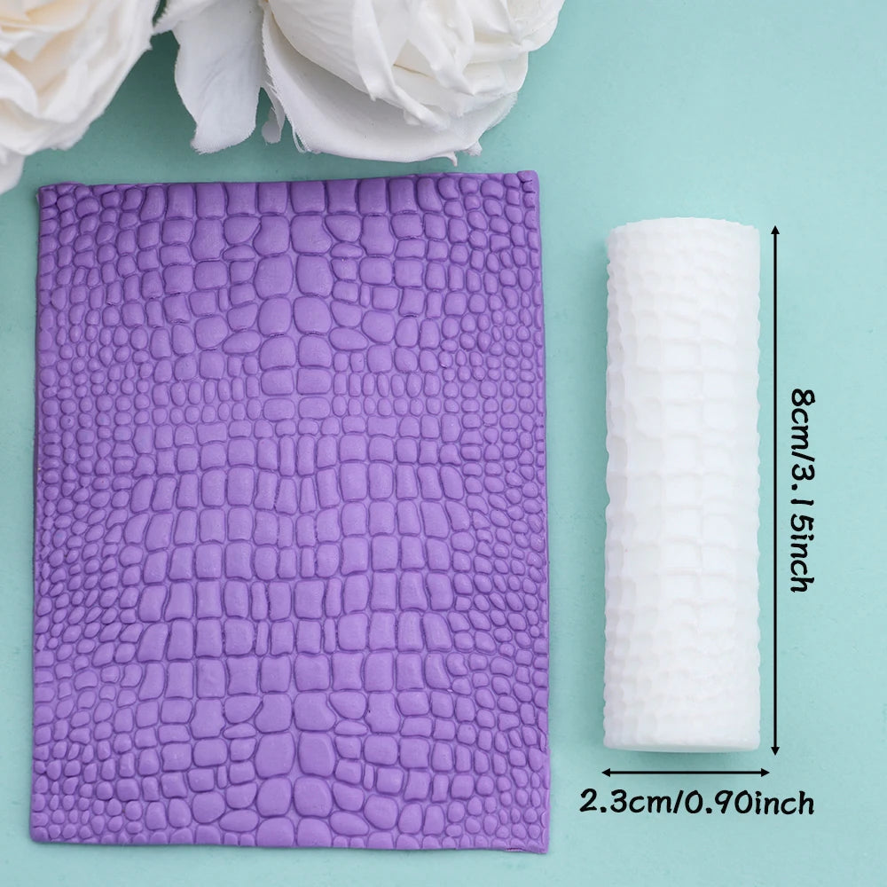 Purple textured clay rollers next to white rolled material on a light green background.