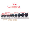 A row of black plastic safety eyes for amigurumi with locking washers shown next to a ruler.