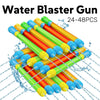 A collection of 24 to 48 water blaster guns in various colors, including orange, yellow, and green, being used to spray water