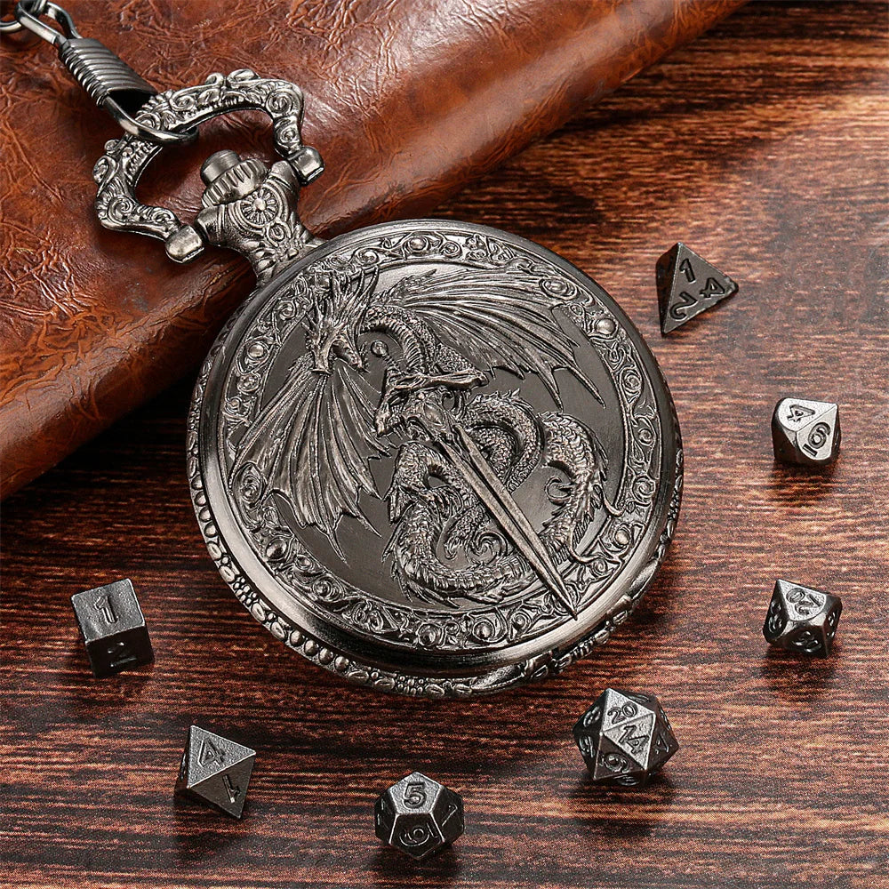 A silver steampunk dragon pocket watch dice case with seven small dice resting on a dark wooden surface.