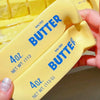 Yellow squishy butter fidget toys in a rectangular shape, showing the net weight of 4 oz.