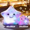 A pair of glowing star-shaped plush pillows with LED lights resting on a surface.