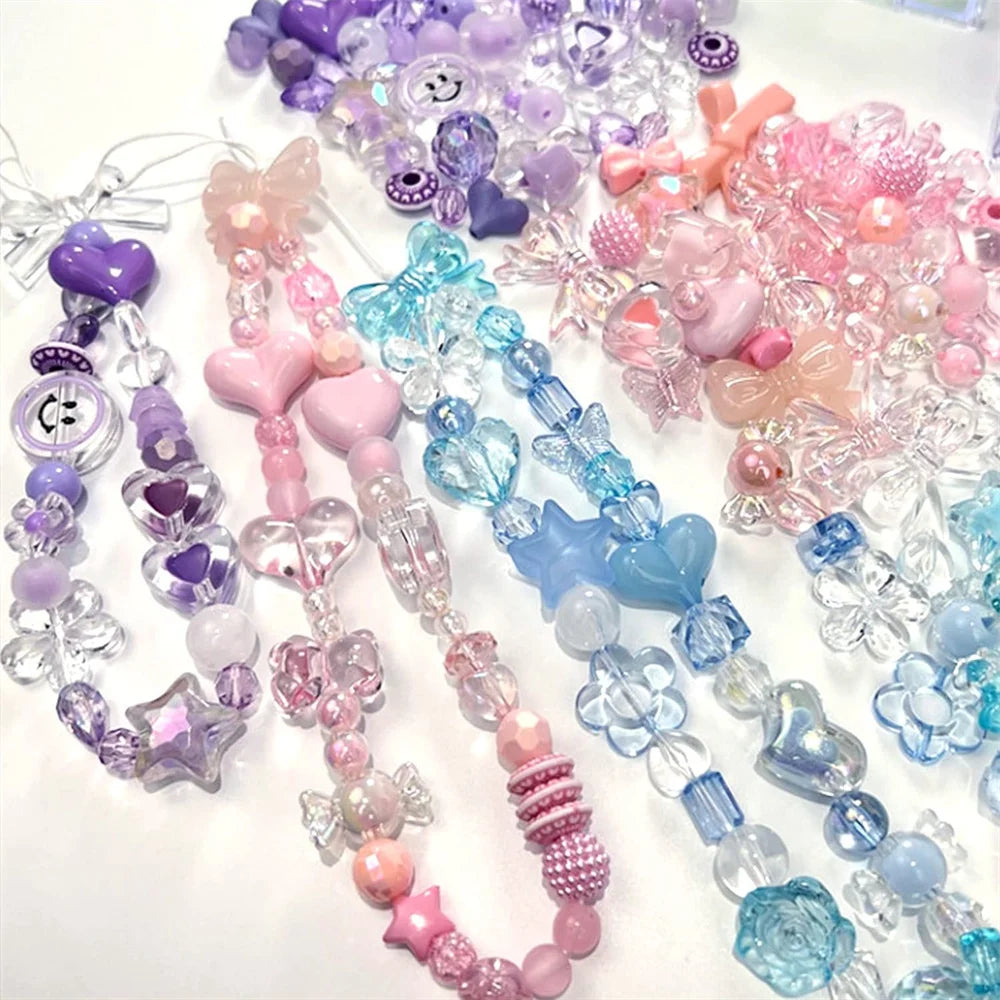 A collection of mixed acrylic bow and flower beads in various shades of purple, pink, blue, and clear for jewelry making.