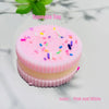 Pink and white layered biscuit squishy toy with colorful sprinkles