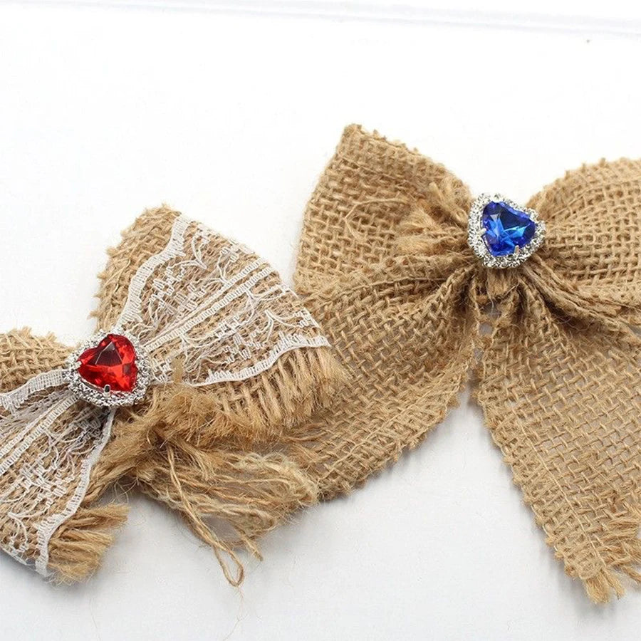 A handmade craft bow featuring burlap ribbon and heart-shaped blue rhinestones.