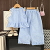 Girls' blue and white checkered lace vest and wide-leg pants set displayed on a wooden hanger.