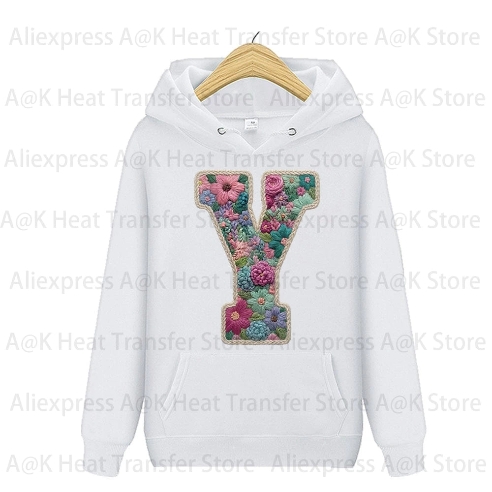 White hoodie featuring a large embroidered floral letter Y design on the chest