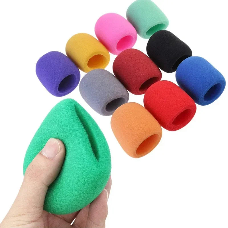 A hand holds a multi-pack of colorful microphone windscreen foam covers.