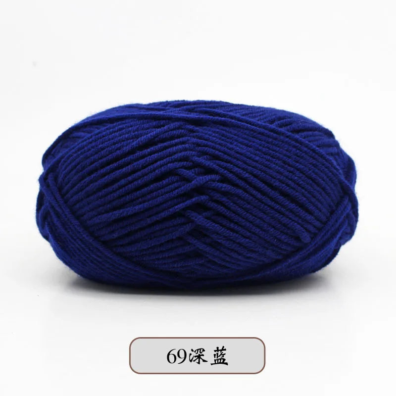 A ball of deep blue pre-dyed milk cotton yarn used for knitting and crochet.