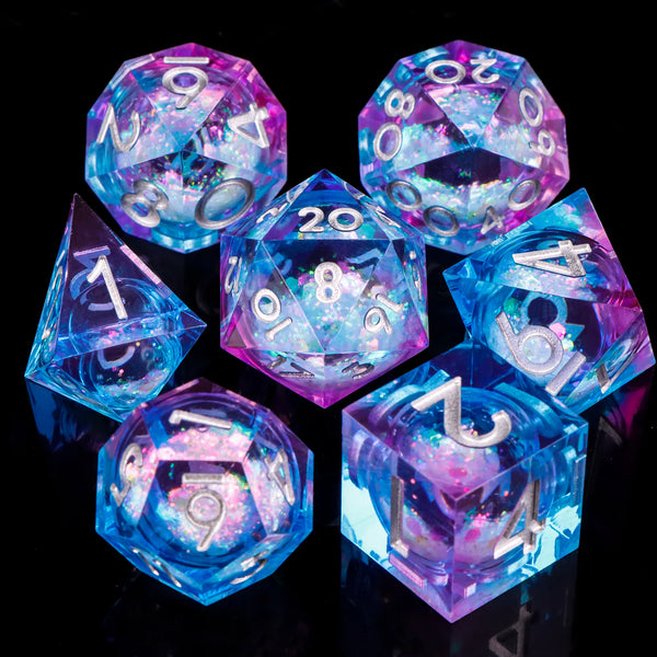 A set of seven iridescent liquid core resin polyhedral dice in various colors and shapes