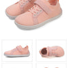 Pink knitted minimalist sneakers for kids shown from the side and top view.