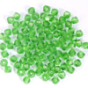 A pile of bright green faceted crystal bicone glass beads for jewelry making.