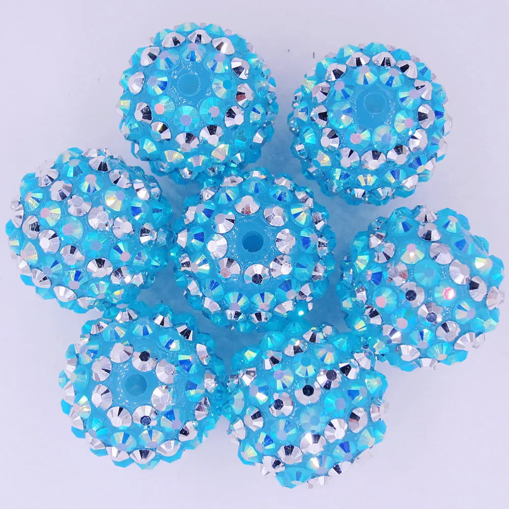 A cluster of bright blue and silver mixed two-tone striped resin beads for jewelry making