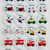 A collection of circular wooden memory matching game cards featuring various vehicles like police cars, trains, ambulances, t