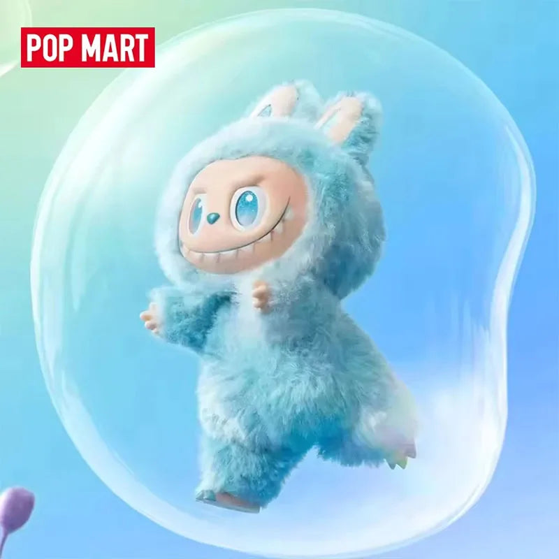 A fluffy blue monster plush doll with large eyes and a wide smile is shown inside a clear bubble.