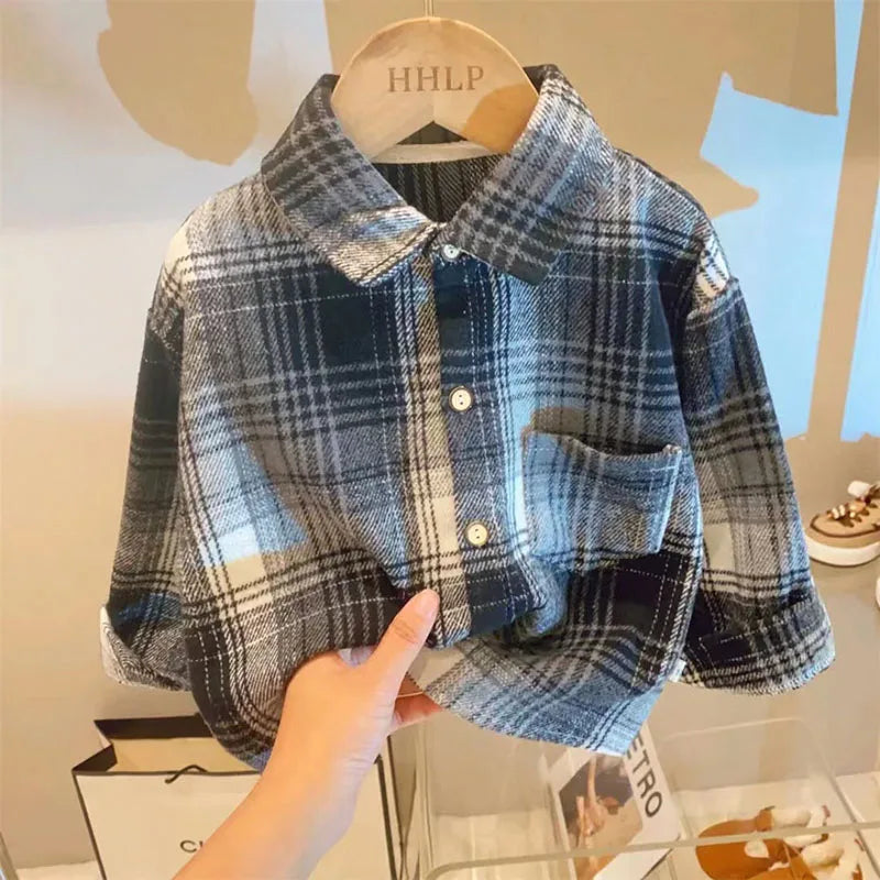A plaid button-up shirt with blue and gray tones is displayed on a hanger.