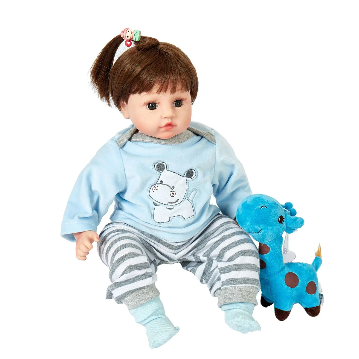 A baby doll wearing a light blue animal romper set with gray striped pants and blue shoes.