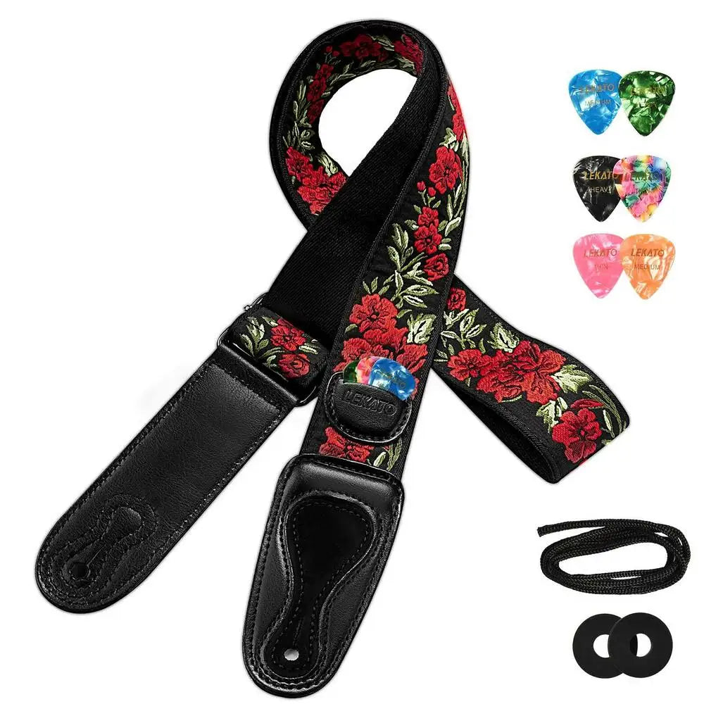 Black guitar strap with red floral pattern, featuring picks and strap locks.