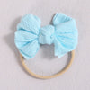 Light blue soft elastic hair band with a bow tied at the center