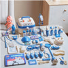 A kids doctor play set featuring a pink stuffed animal, medical tools, and a white suitcase-shaped toy.