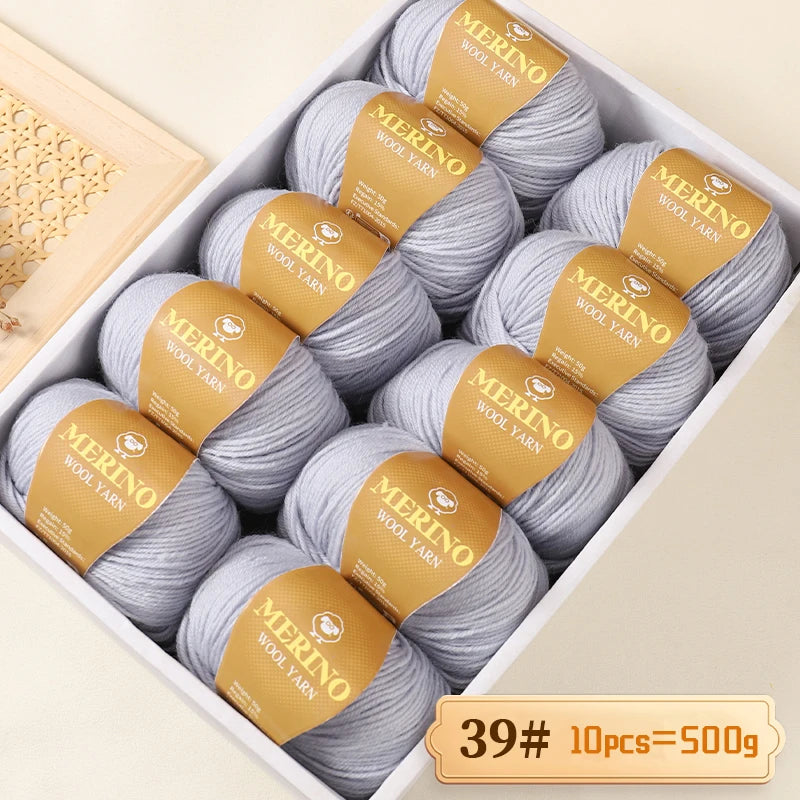 Box of Merino wool yarn balls with yellow labels for knitting and crafting