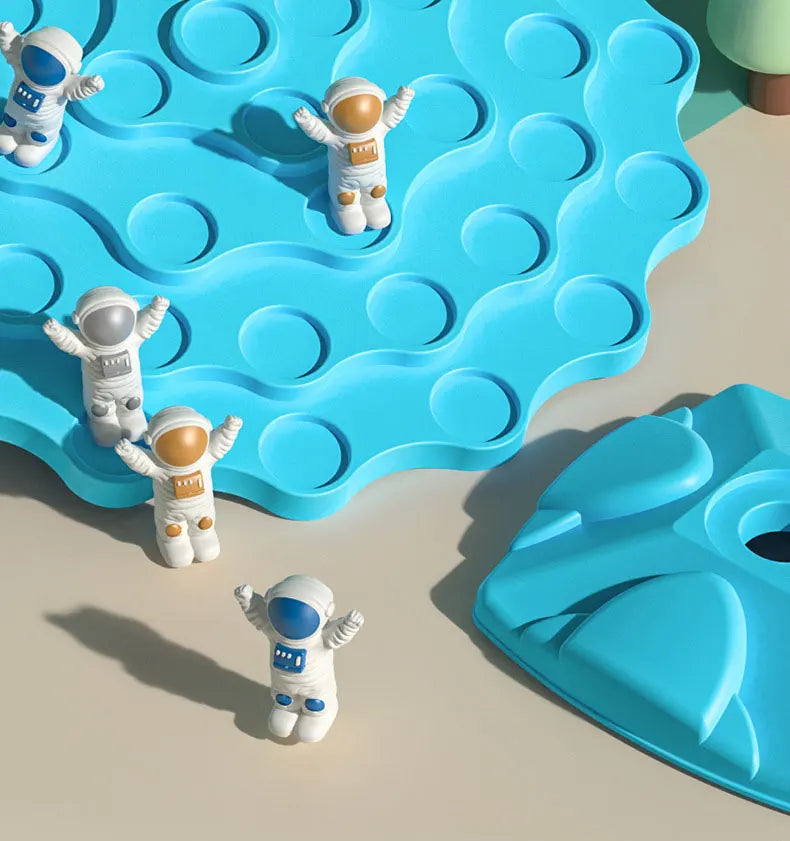A set of white and blue astronaut figures are placed on a blue, wavy plastic tree balance game board.