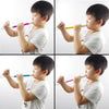 A young boy plays a classic slide whistle musical toy, demonstrating its use.