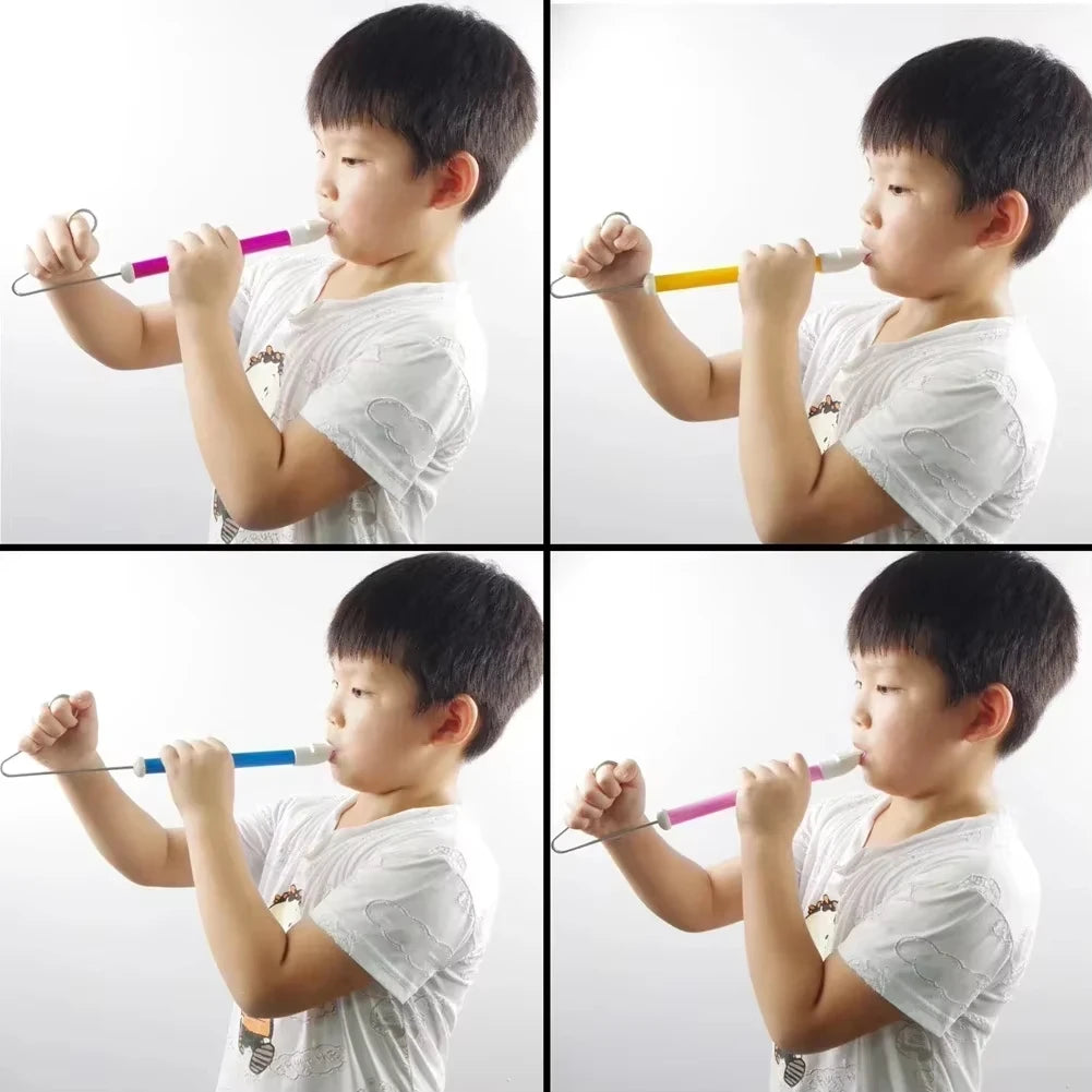 A young boy plays a classic slide whistle musical toy, demonstrating its use.