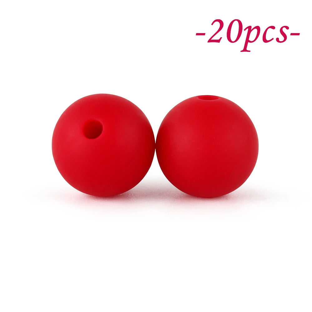 Two bright red silicone beads are shown against a white background.