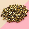 A pile of small, gold-colored electroplated crystal glass beads for jewelry making.