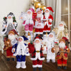 A collection of Christmas Santa Claus figurines in various outfits and sizes for holiday decor.