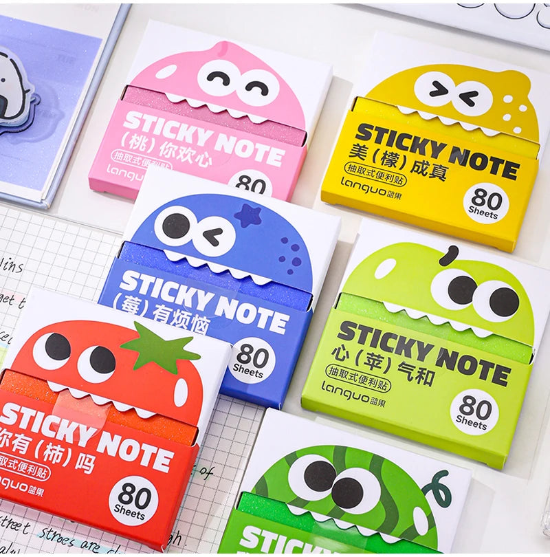 A collection of colorful sticky notes in various shapes and colors, including pink, yellow, blue, and green, packaged for sal