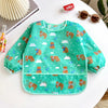 A green full-sleeve waterproof baby bib featuring a cartoon design of bears and clouds.