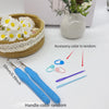 A set of ergonomic crochet hooks, stitch markers, and needles in various colors are displayed on a white surface.