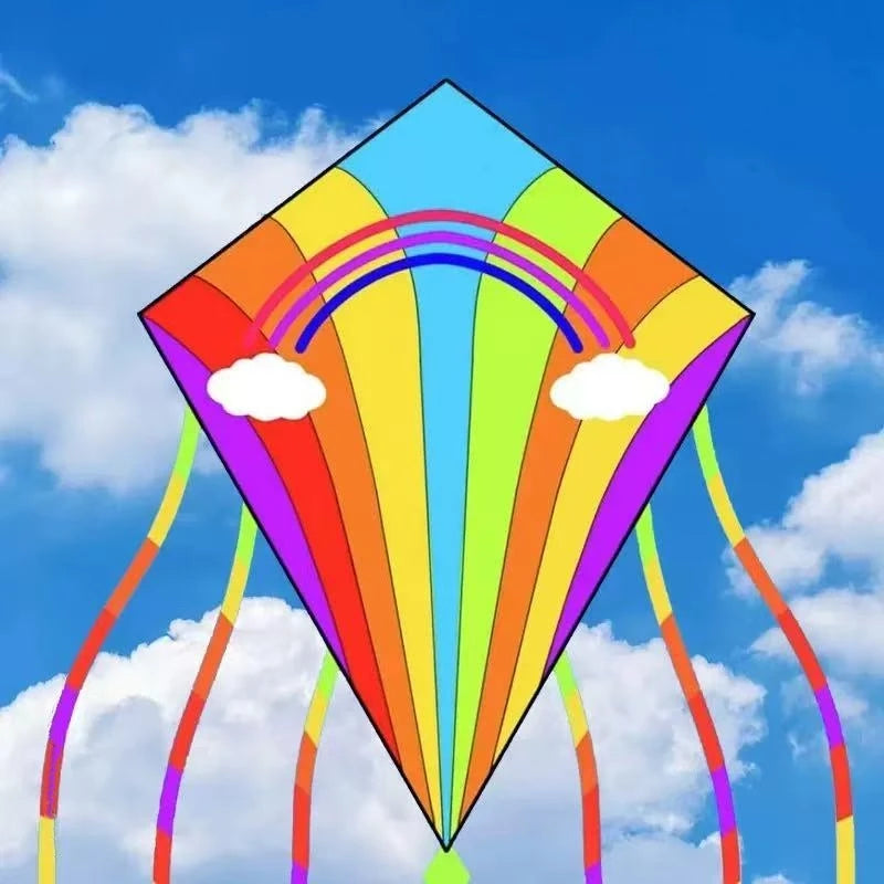 A colorful diamond-shaped kite with rainbow stripes and arcs is shown against a blue sky.
