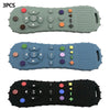 Three silicone chew toys shaped like remote controls in green blue and black.