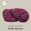 A ball of deep magenta merino wool yarn labeled as Lirisnly's hand-picked 300g Merino.