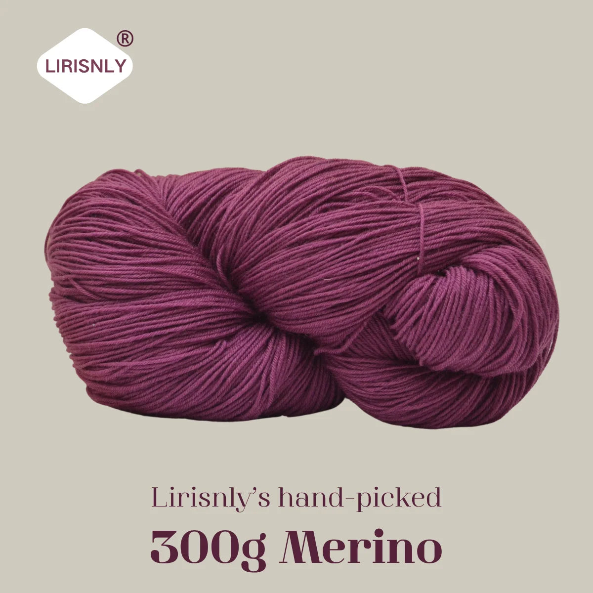 A ball of deep magenta merino wool yarn labeled as Lirisnly's hand-picked 300g Merino.