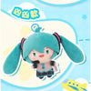 A soft teal plush doll of Hatsune Miku with pink hair and a light blue outfit, shown against a light blue background.